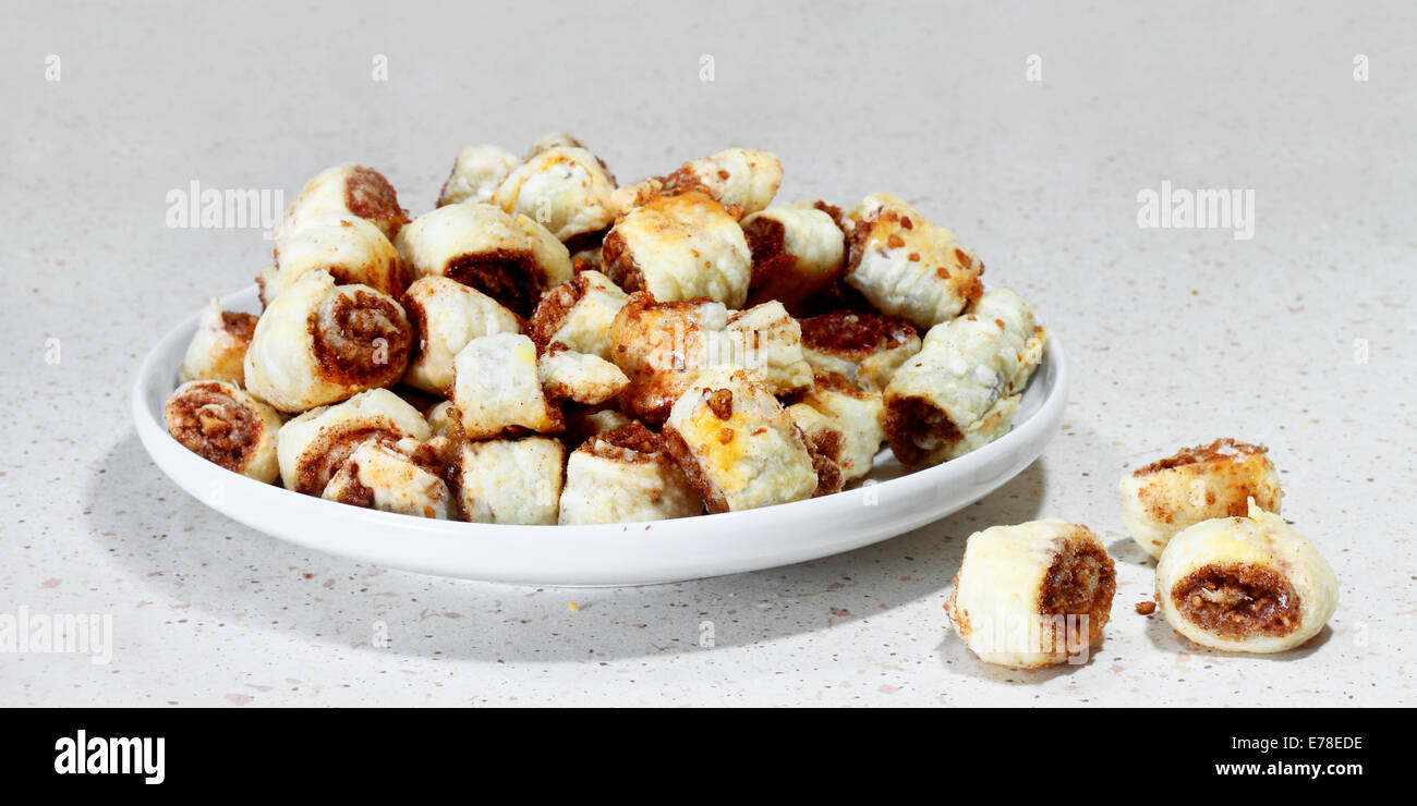 Dish of cinnamon buns on gray table Stock Photo