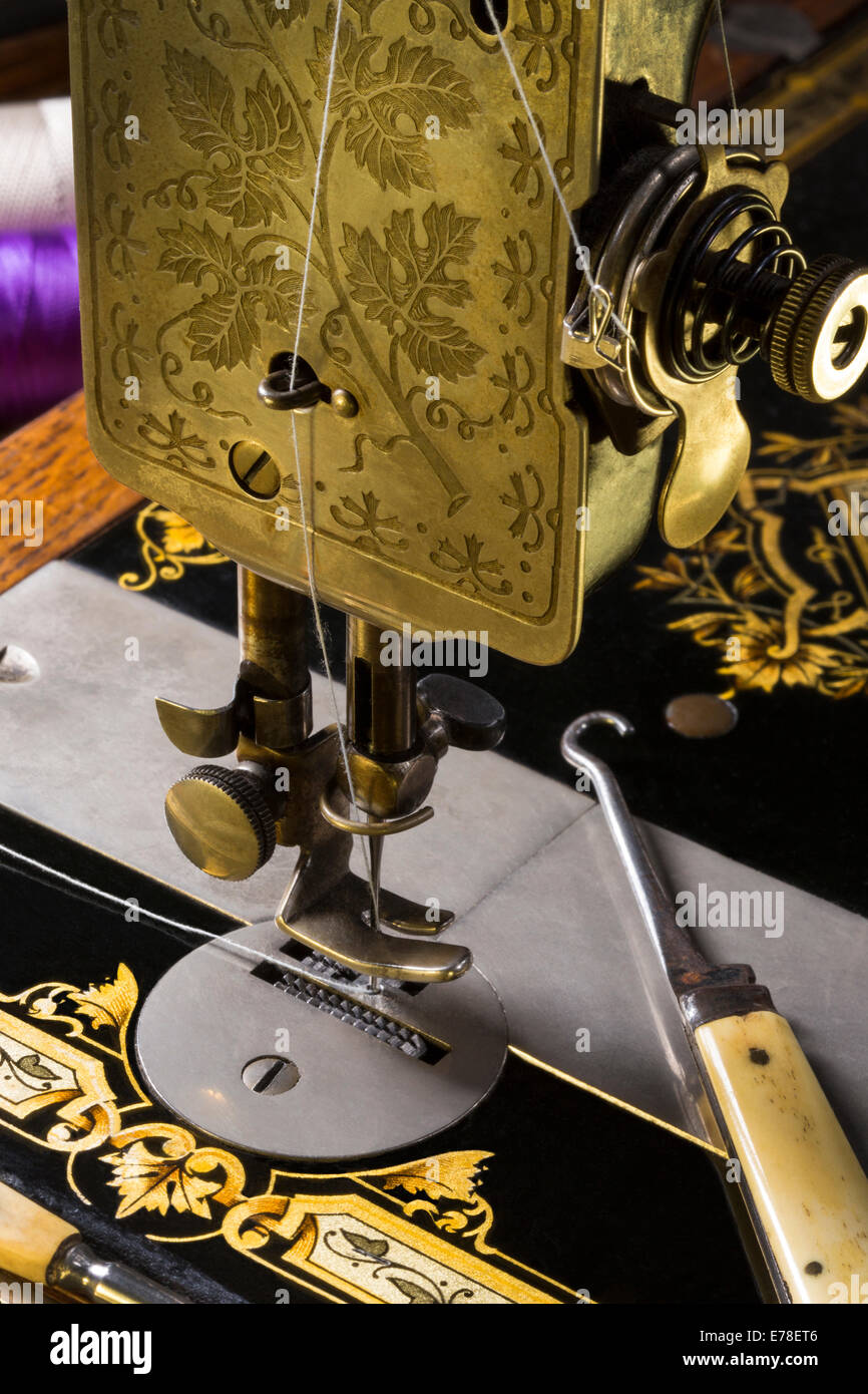 Antique Sewing Machine with gold decoration. Stock Photo