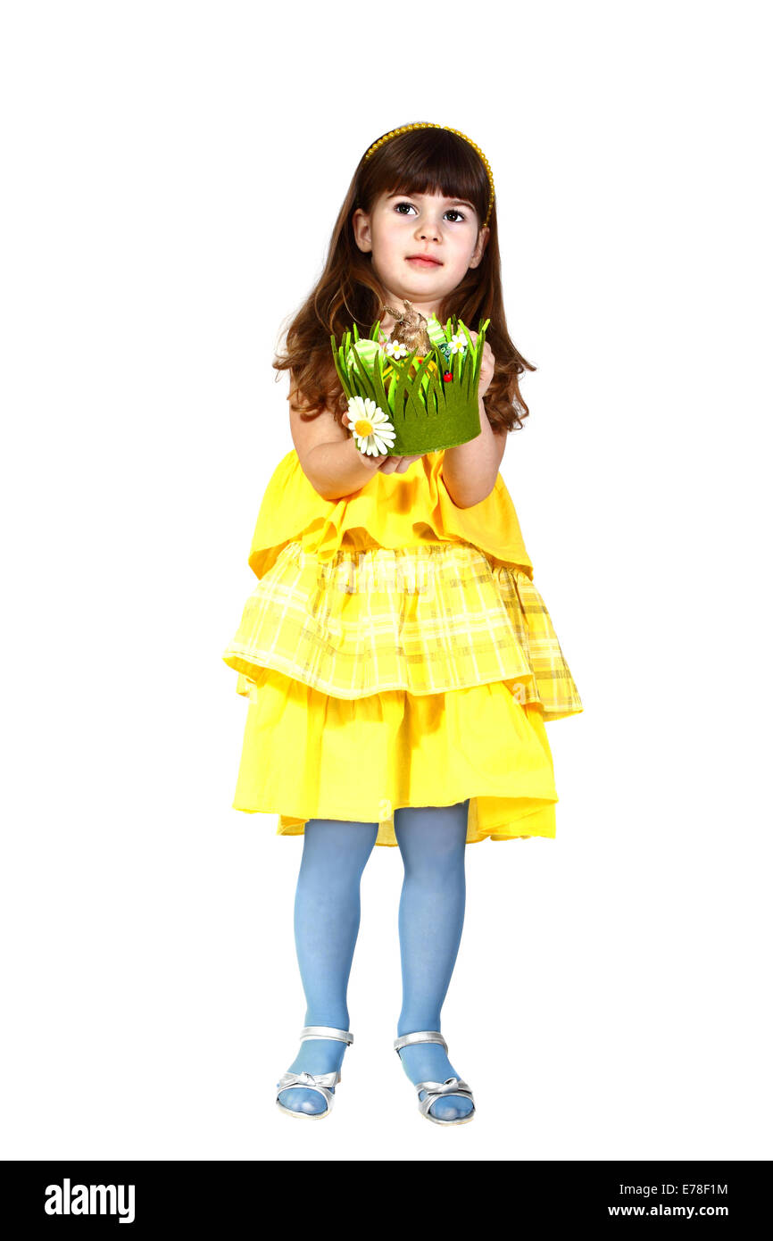 Cute little girl in yellow dress and blue stockings with easter bunny in hands. Full height shot isolated on white background Stock Photo