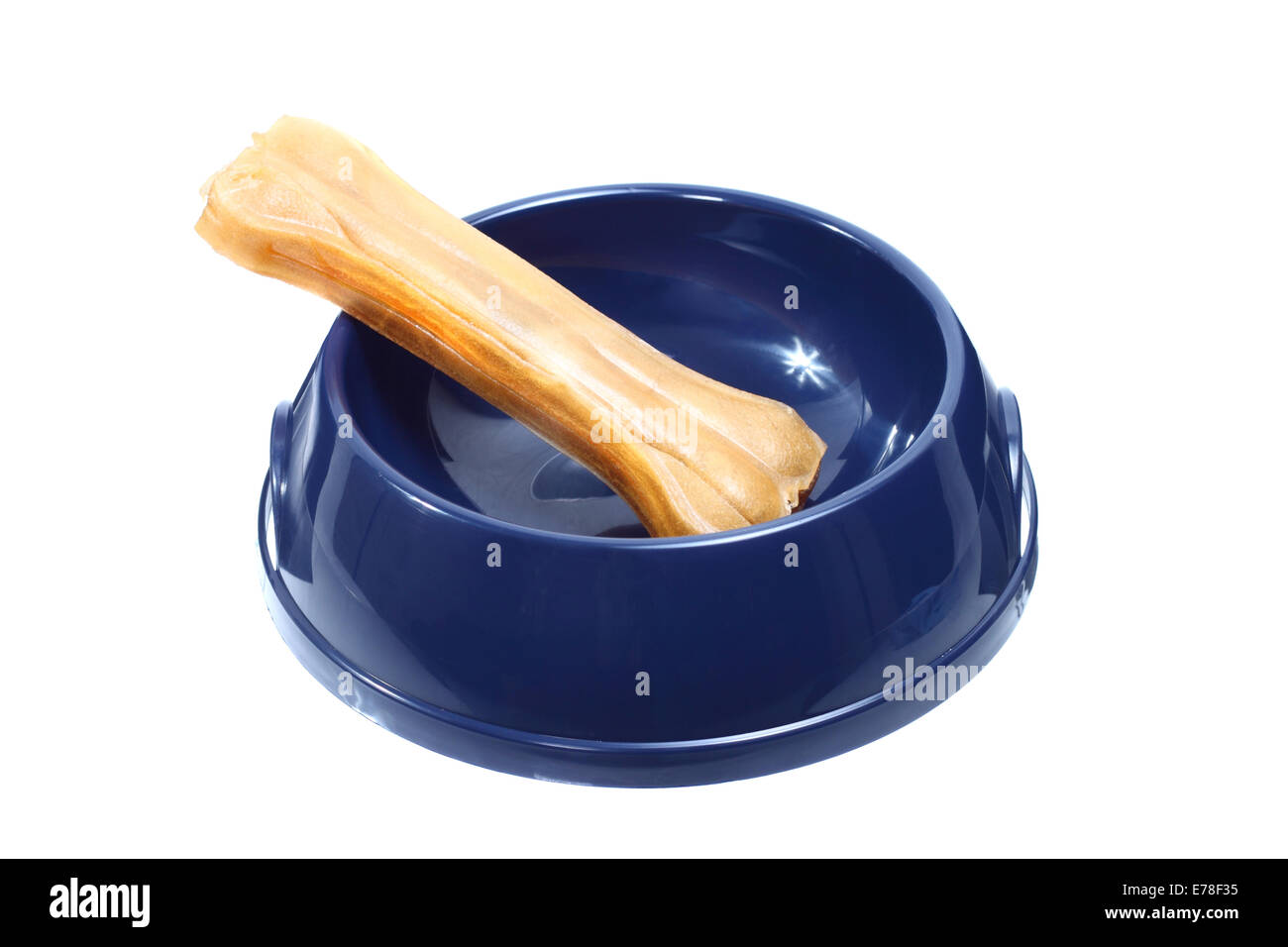 Dog bone in blue plastic bowl isolated on white background Stock Photo