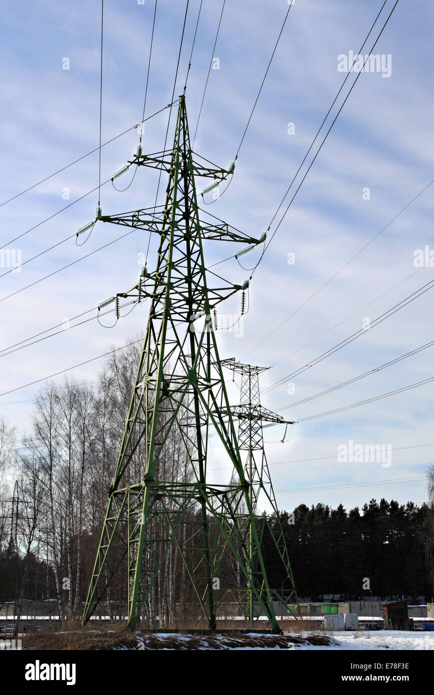 Power transmission line supports under cloudy blue sky Stock Photo - Alamy