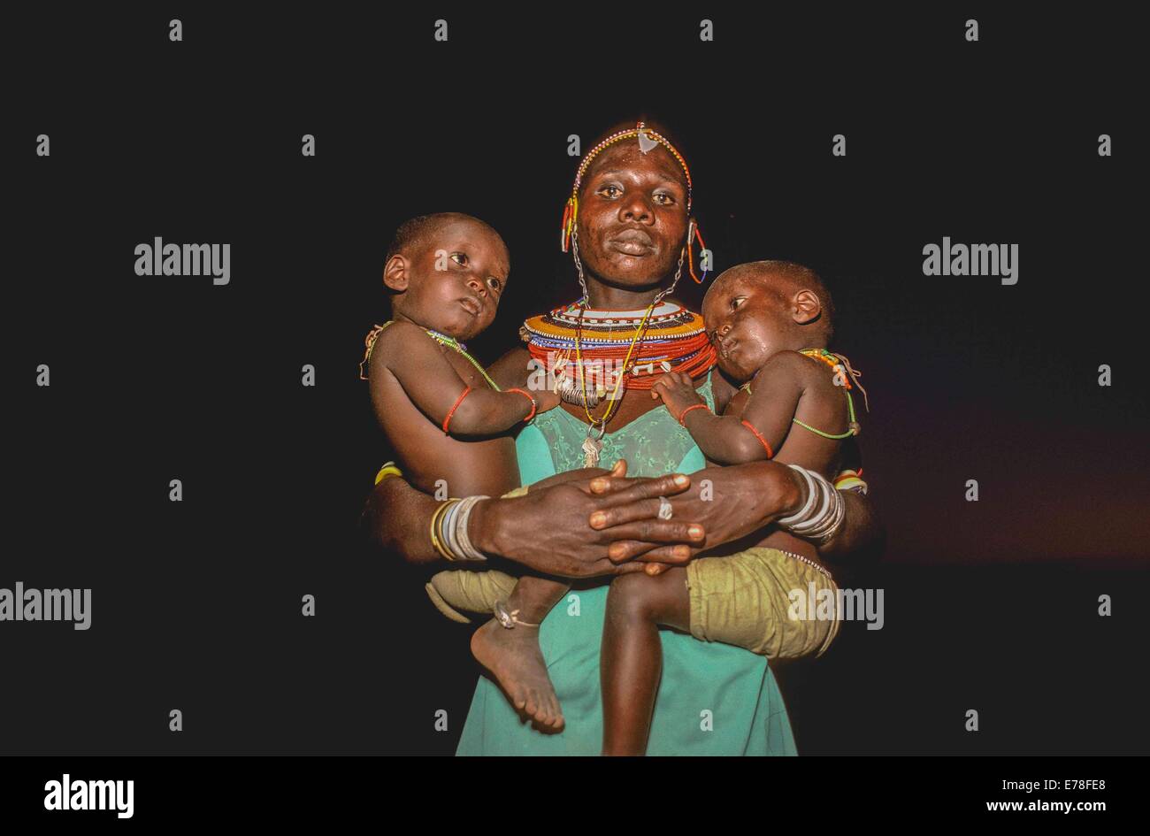 El Molo tribal woman with two children at Hippo Ceremony, El Molo Tribe, Lake Turkana - Kenya. Stock Photo