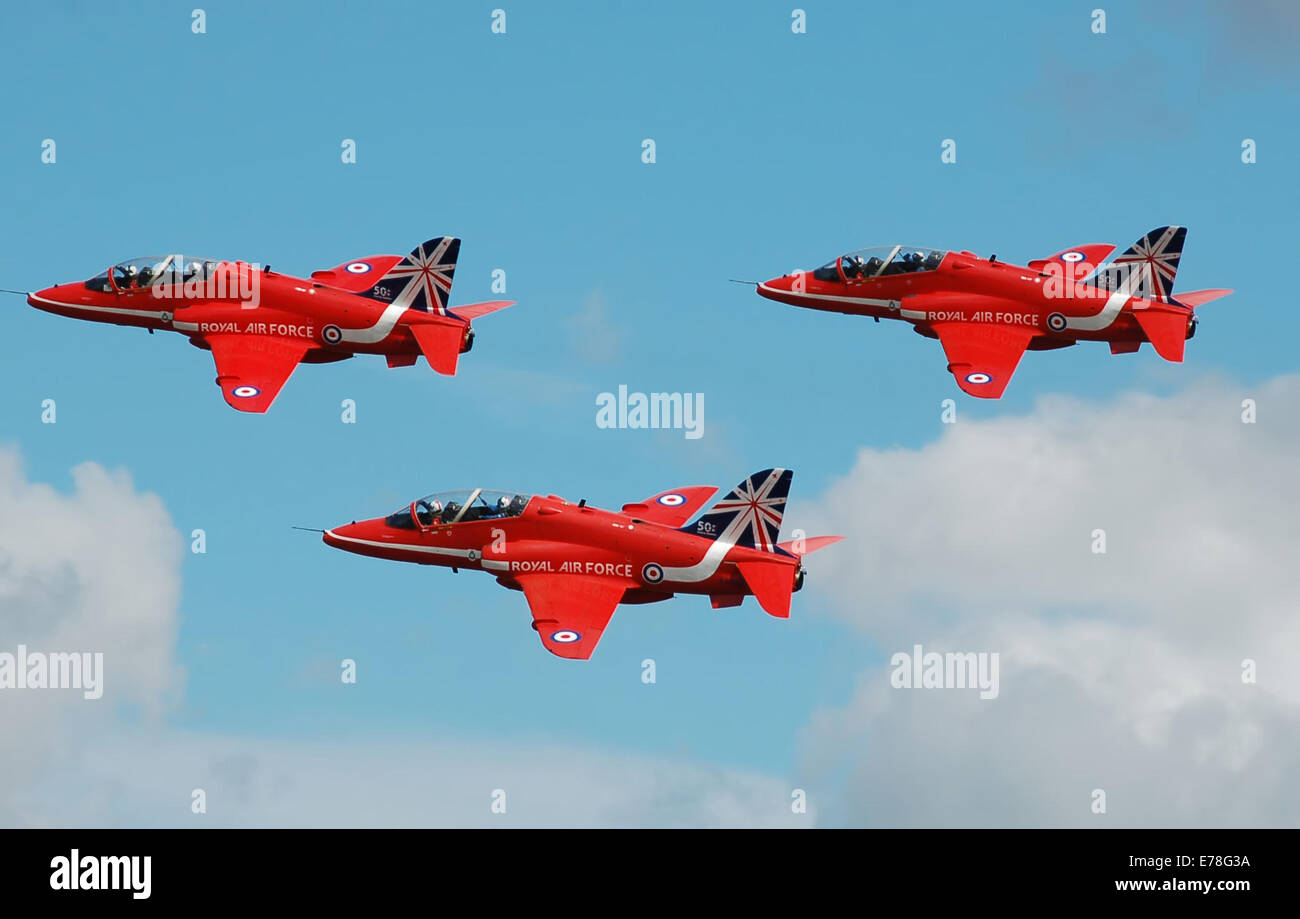 The RAF Red Arrows aerobatic display team depart Fairford, England, after the 2014 Royal International Air Tattoo. They are in a colour scheme that commemorates their 50th year. Stock Photo