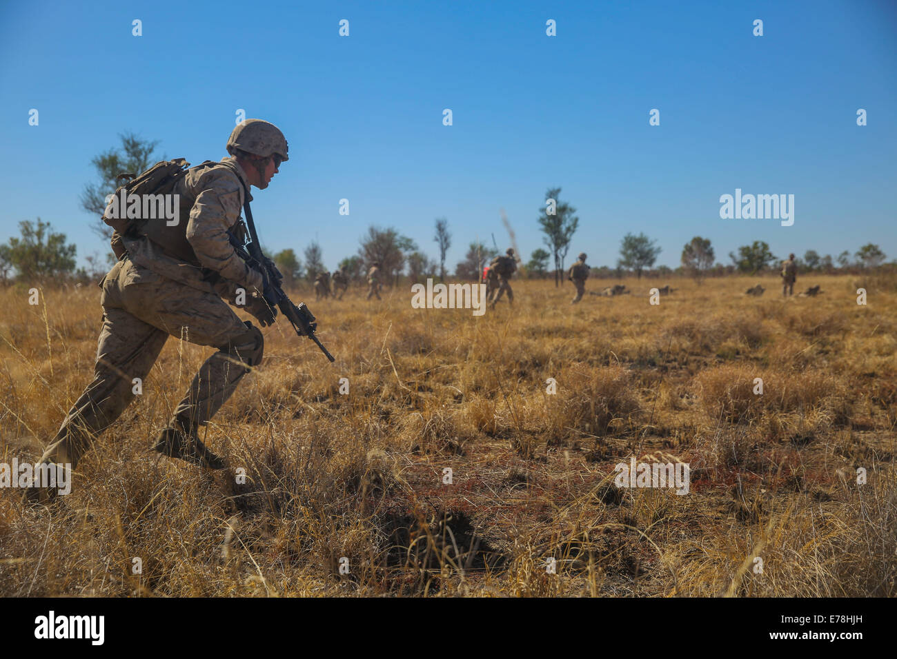 U.S. Marines with Alpha Company, 1st Battalion, 5th Marine Regiment, Marine Rotational Force-Darwin assault an enemy position during Koolendong 2014 at Bradshaw Field Training Area, Australia, Aug. 16, 2014. Koolendong is an amphibious and live-fire exerc Stock Photo