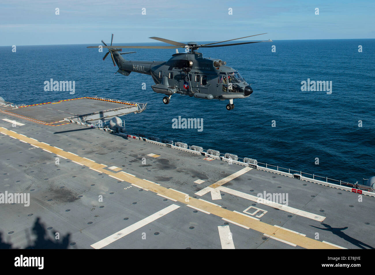 A Chilean Navy helicopter assigned to Helicopter Attack Squadron (HA) 1 prepares to land on the flight deck of the amphibious assault ship USS America (LHA 6) during a bilateral exercise in the Pacific Ocean Aug. 27, 2014. The America embarked on a missio Stock Photo