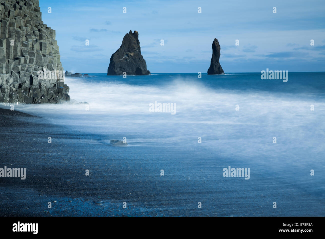 the Reynisdrangar basalt sea stacks and the Reynisfjara black sand beach near the village Vík í Mýrdal, southern Iceland Stock Photo