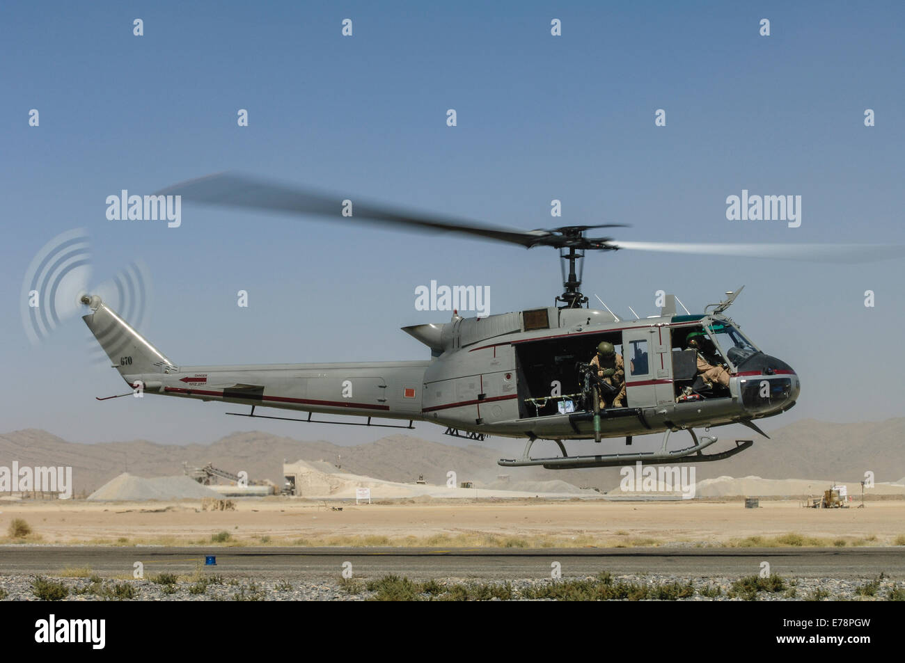 Bell Huey II landing at Kandahar Airfield Stock Photo