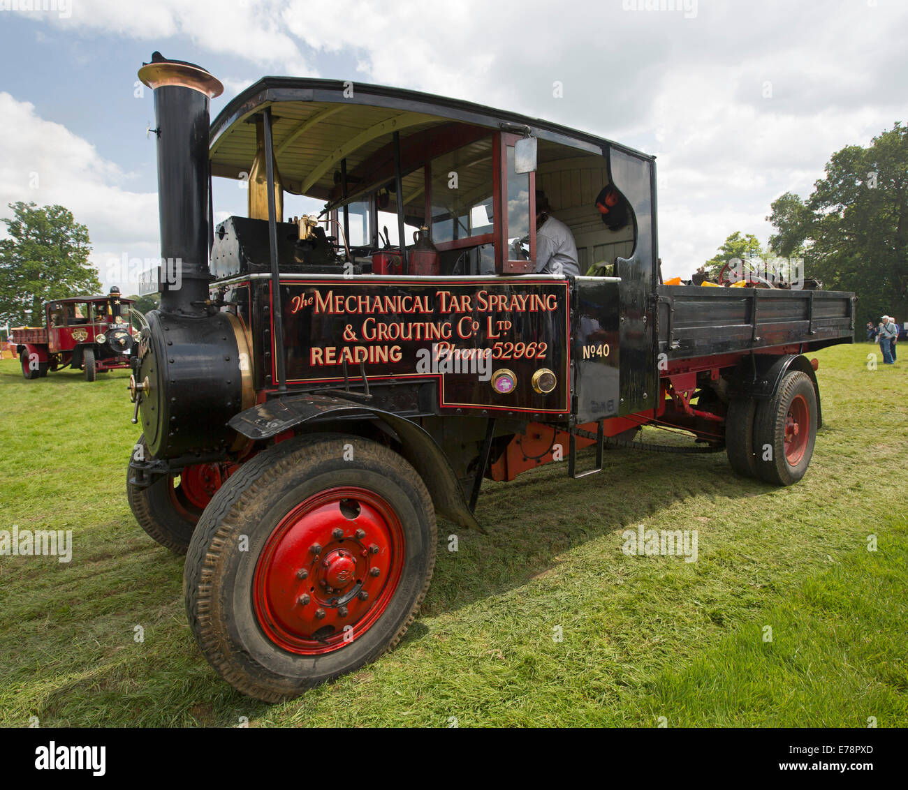 Immaculately restored operational steam lorry with red and black paintwork on display at English country fair Stock Photo