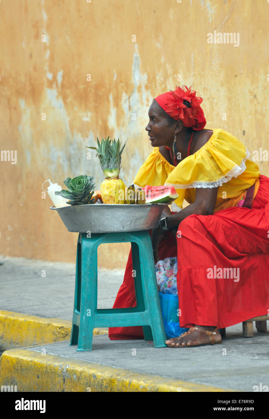 CARTAGENA, MAY 13: Palenquera woman with typical dress sells fruit on the Street on May 13, 2010 in Cartagena, Colombia. Palenqu Stock Photo