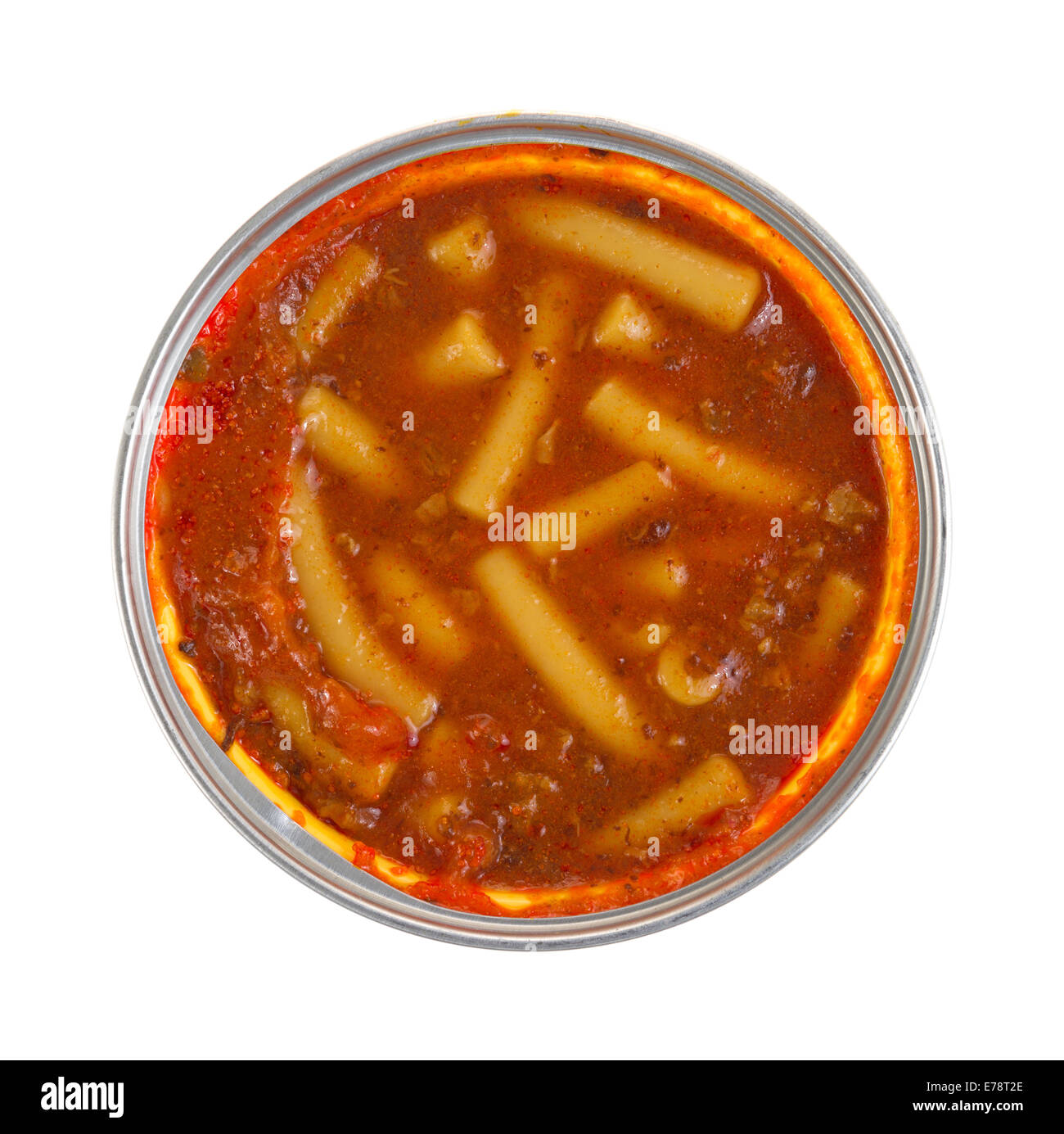 Top view of an opened can of pasta and beef chunks in a tomato sauce on a white background. Stock Photo