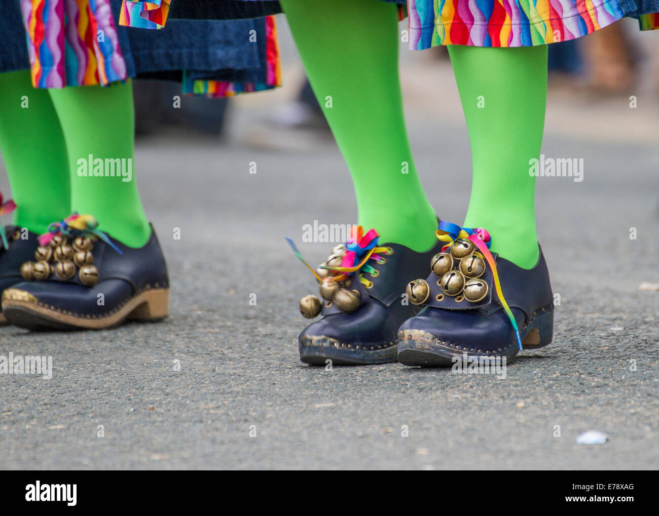 Folk festival black shoes with green tights and bells on with colourful colorful outfits in Swanage, Purbeck, Dorset, England Stock Photo