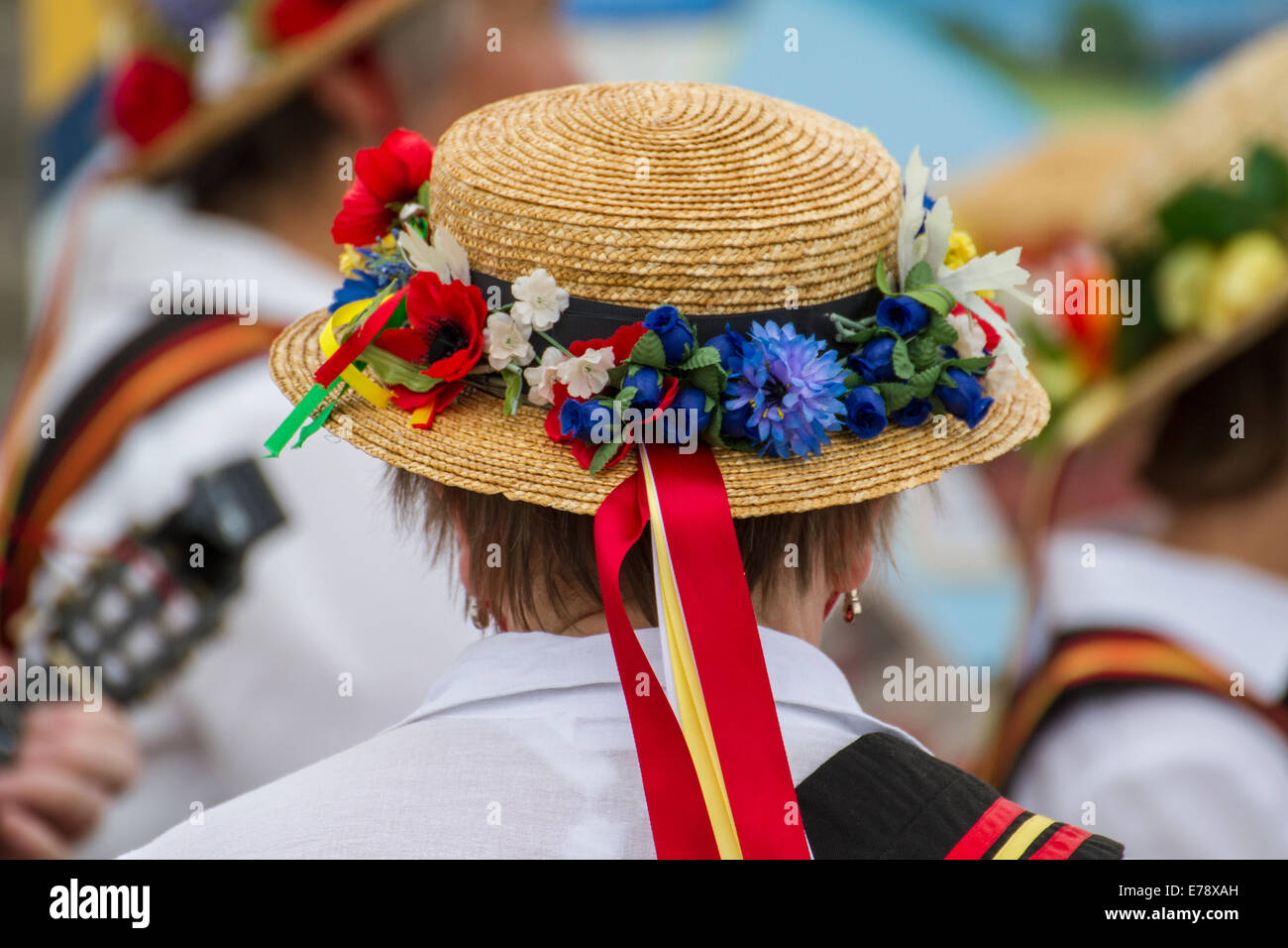 Folk festival fun and enjoyment of traditional dance with flowery straw hat and ribbon Stock Photo