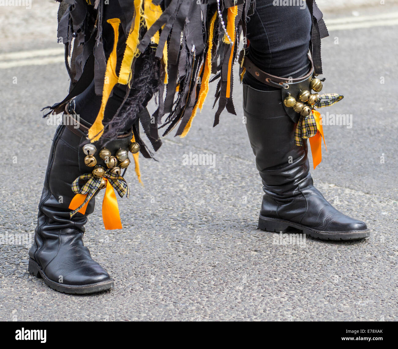 morris dancing at folk festival in road at Swanage, Purbeck, Dorset, UK with yellow and black tassles and bells Stock Photo