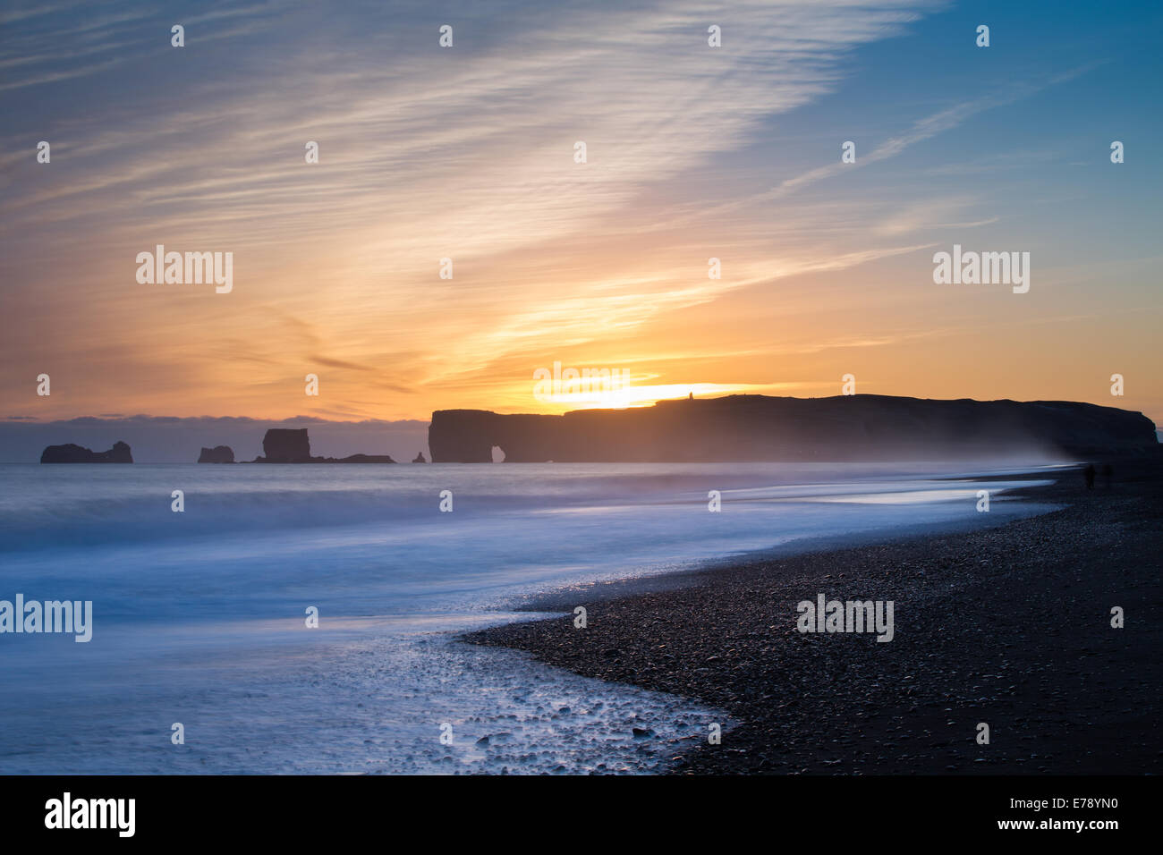 the view along Reynisfjara black sand beach near the village Vík í Mýrdal towards  Dyrhólaey at dusk, southern Iceland Stock Photo