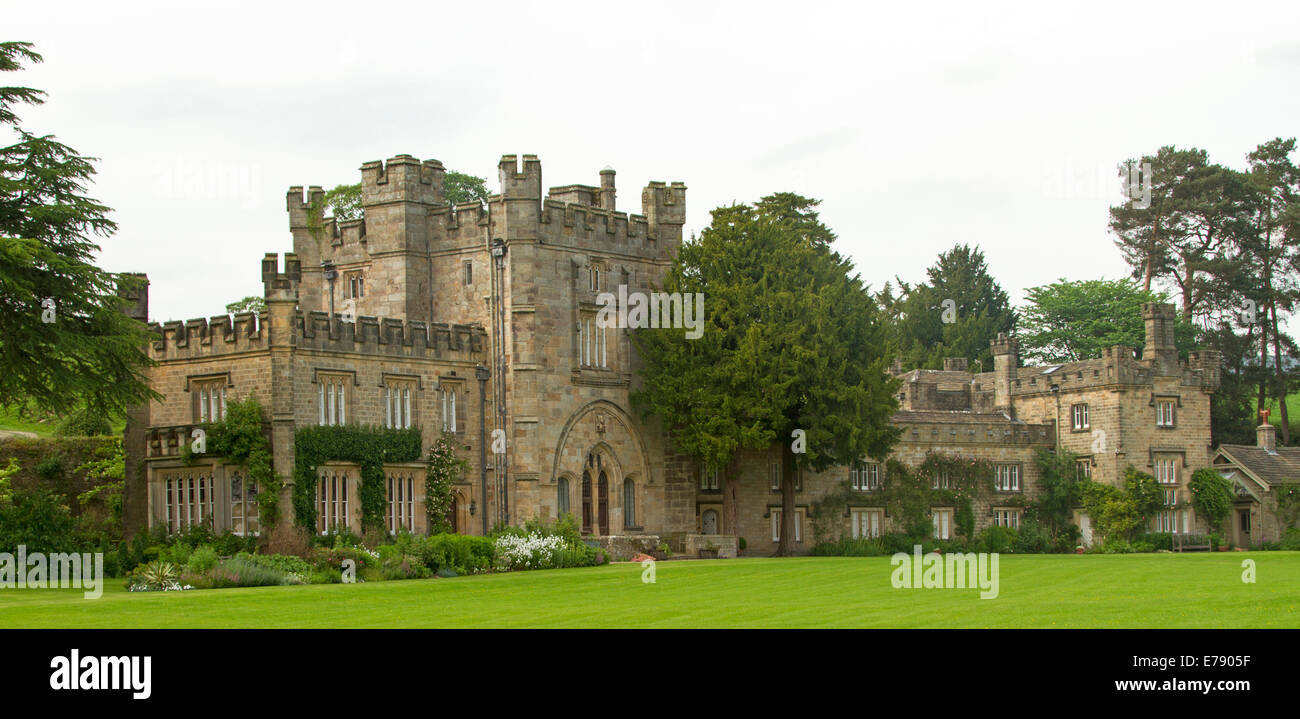 Huge and imposing English stately home, historic Bolton Abbey surrounded by emerald lawns and gardens, in Yorkshire Dales Stock Photo