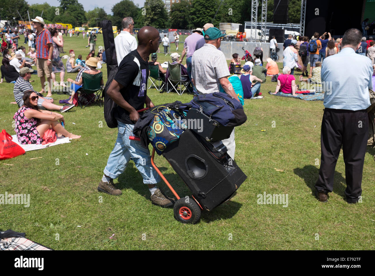 Man wheeling large Music Speaker Trolley Rasta Stock Photo