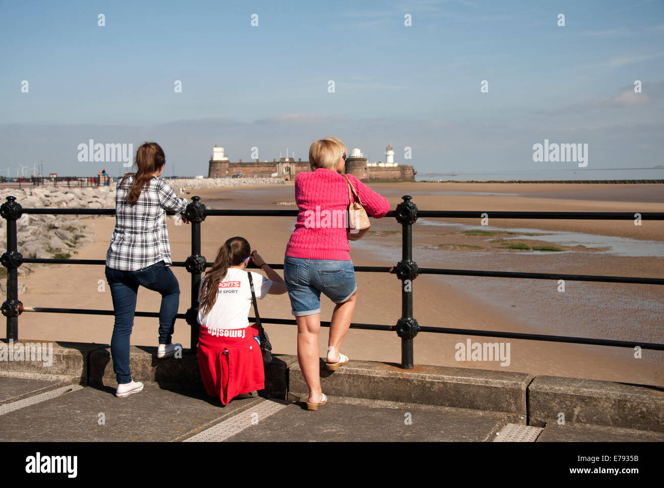 Family Looking Out To Sea Beach Girls Railings Stock Photo