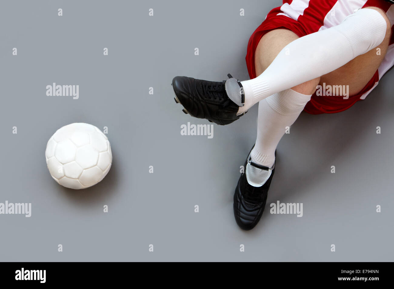 Sports player legs with soccer ball near by Stock Photo
