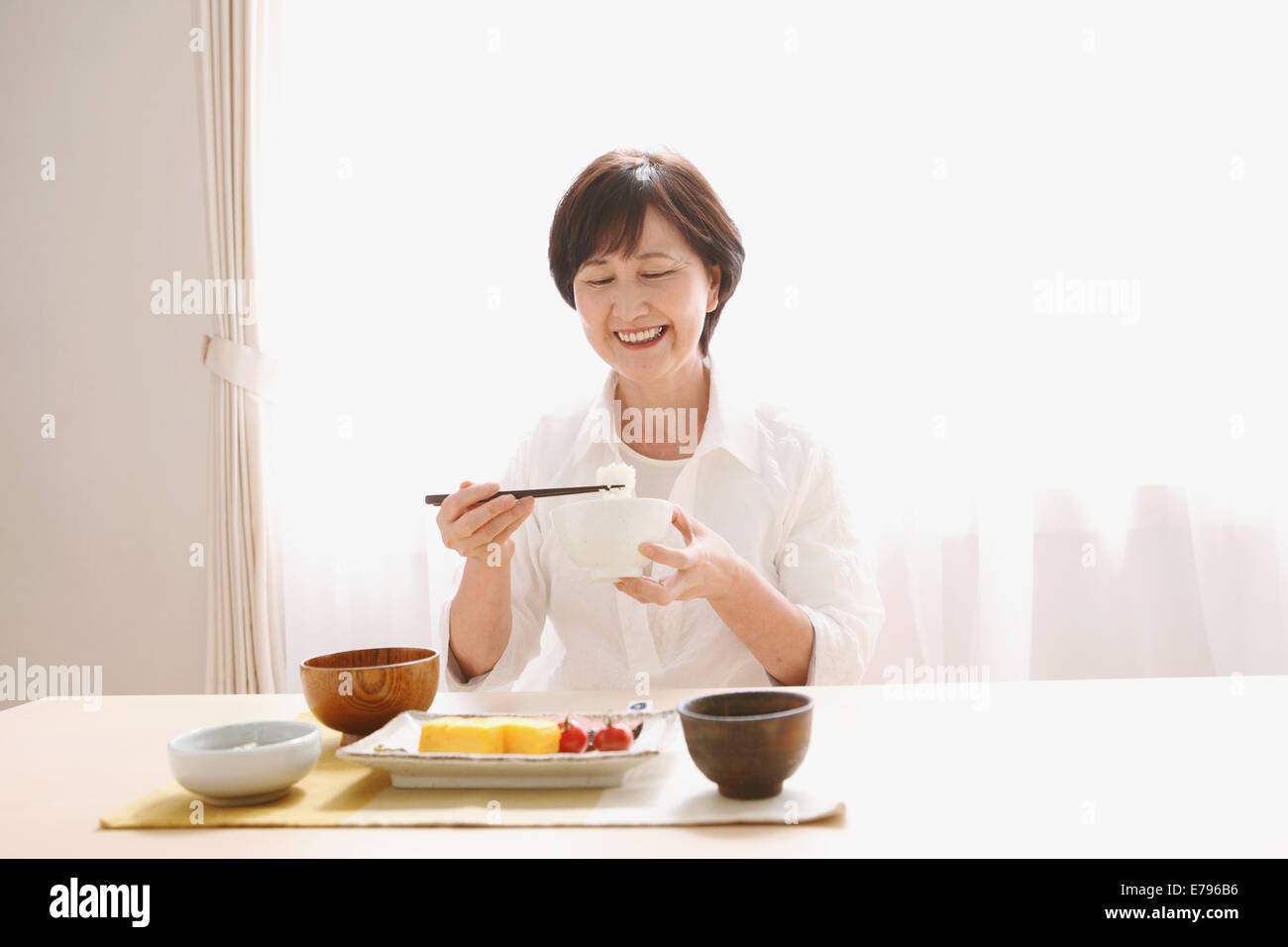 Senior adult Japanese woman eating Stock Photo