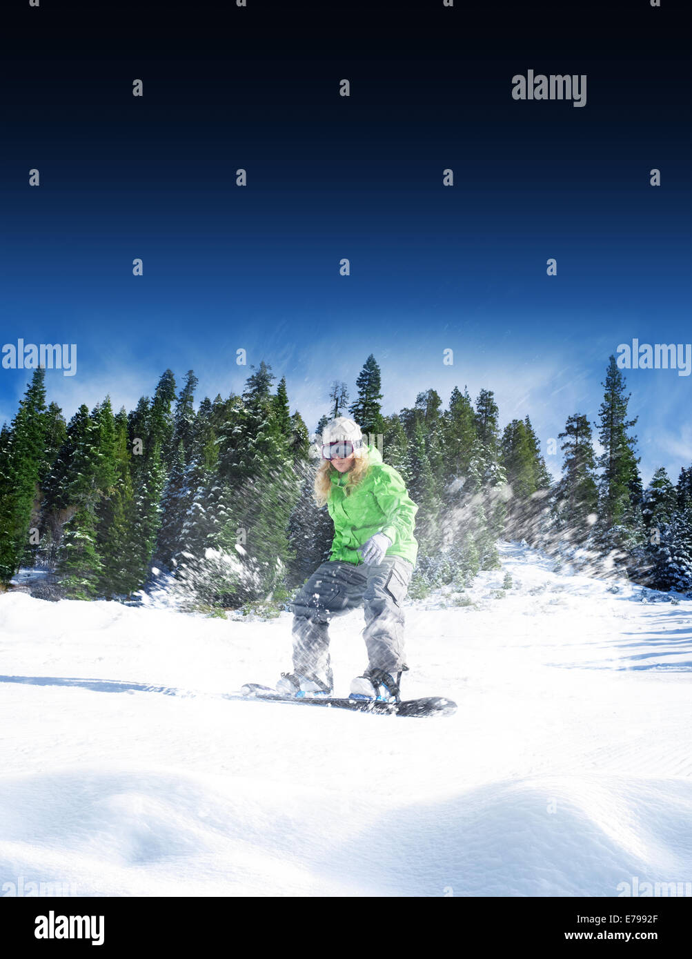 view of a young girl snowboarding in winter environment Stock Photo