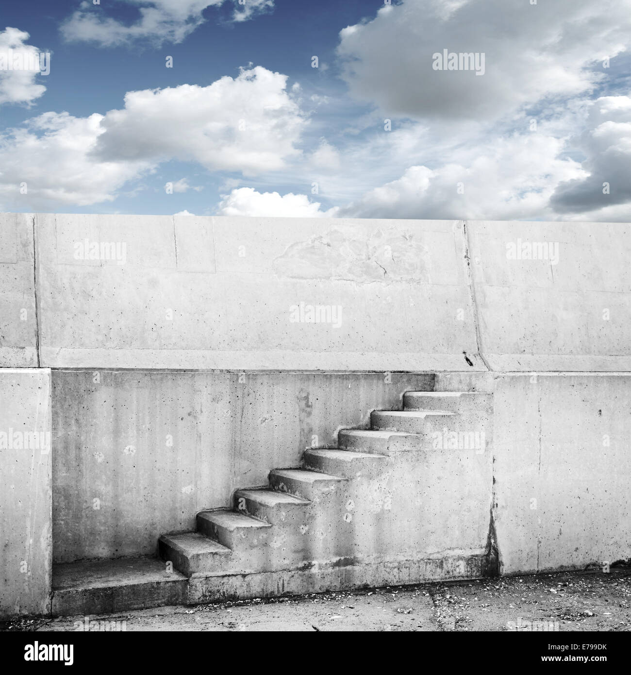 Concrete wall with stairway and blue cloudy sky on background Stock Photo