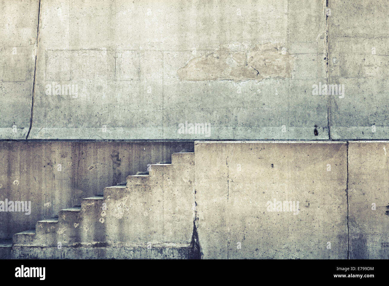 Concrete interior with stairway on the wall, vintage toned Stock Photo