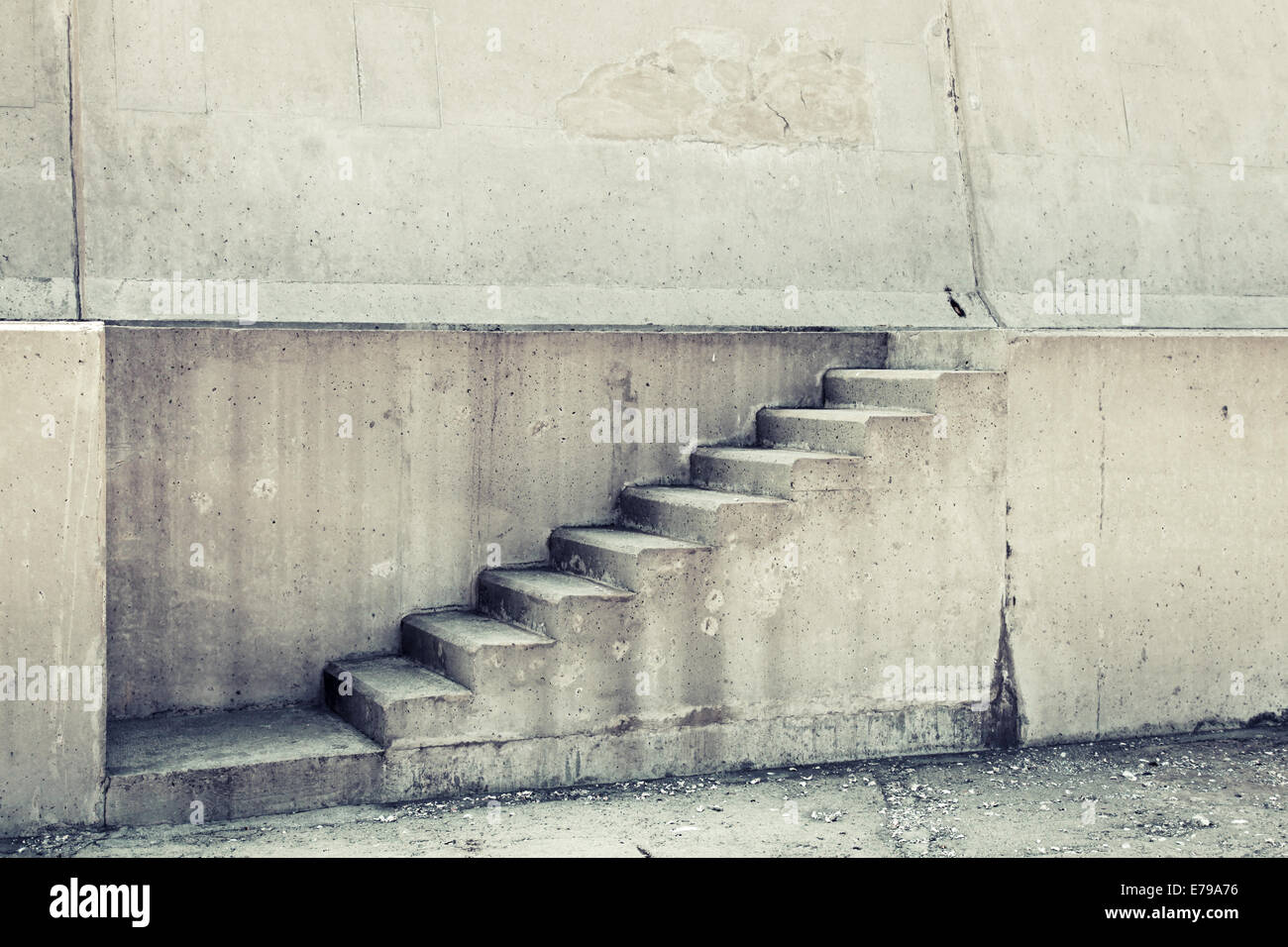 Concrete interior with stairway on the wall, vintage toned photo Stock Photo