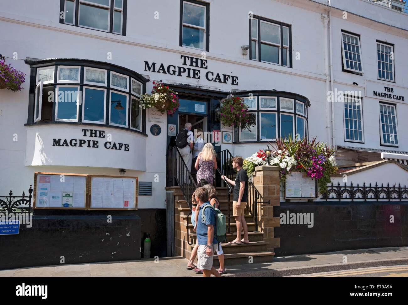 People visitors queuing outside the famous Magpie Cafe fish and chip restaurant in summer Whitby North Yorkshire England UK United Kingdom Britain Stock Photo