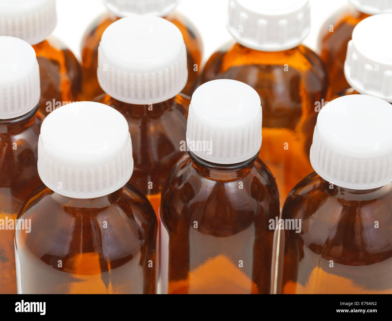 many small closed brown glass oval pharmacy bottles close up Stock Photo