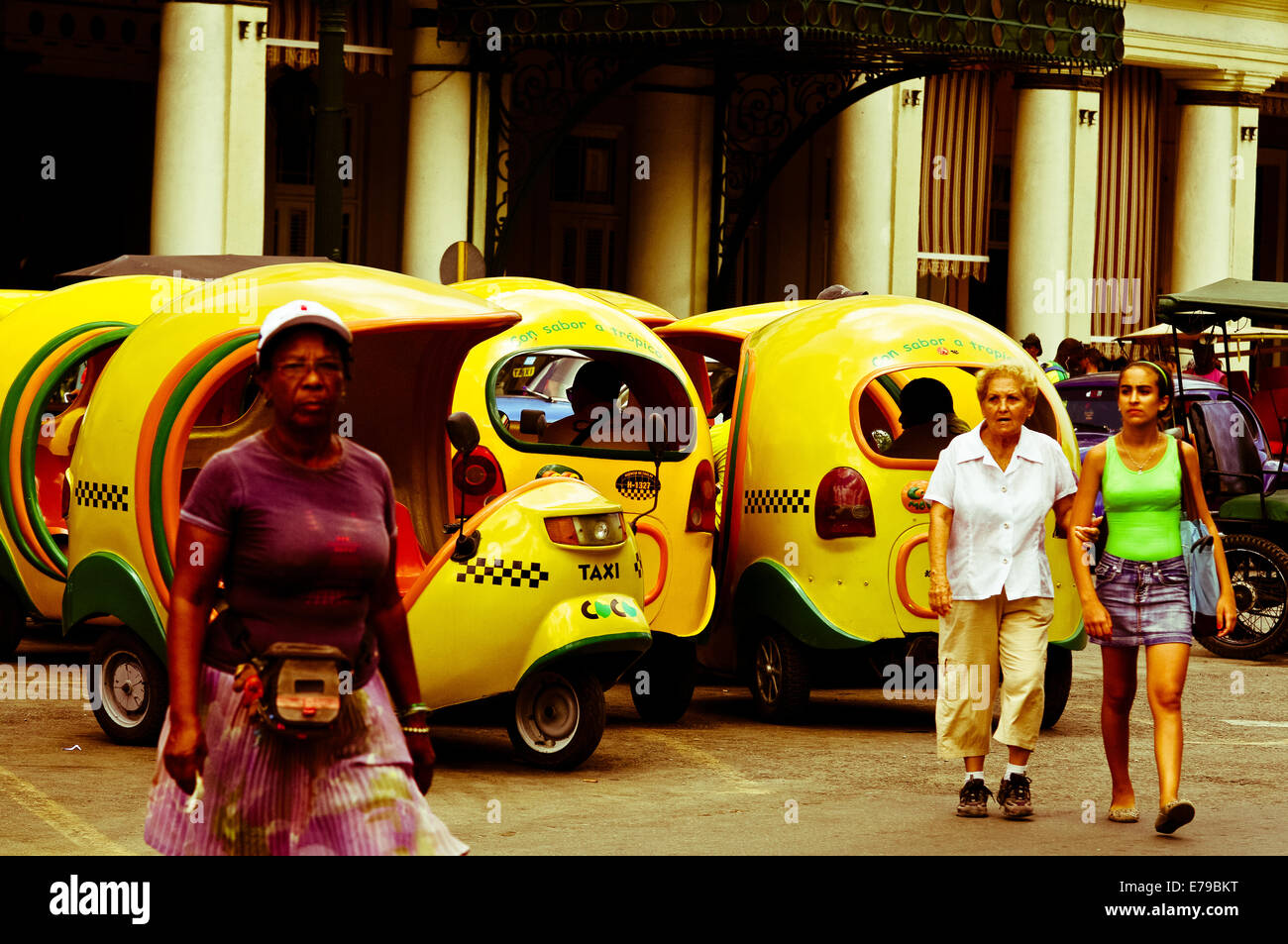 Cocotaxis and pedestrians - Havana, Cuba Stock Photo