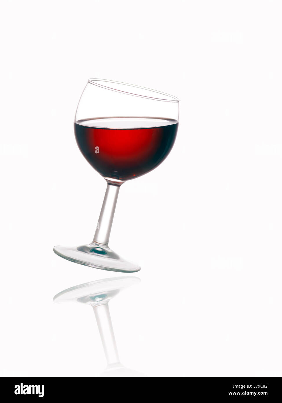 Tilted glass wine on white Cut Out Stock Images & Pictures - Alamy