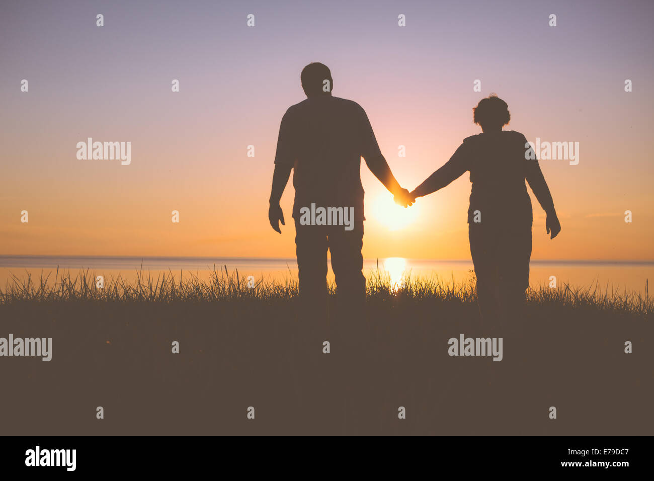 Senior couple holding hands silhouettes Stock Photo