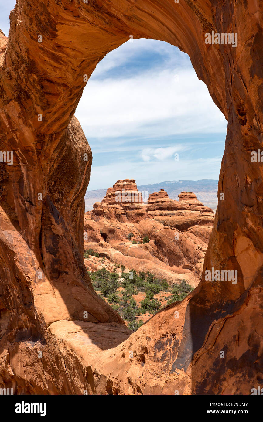 mountain scenery viewed through round arch in Utah Stock Photo