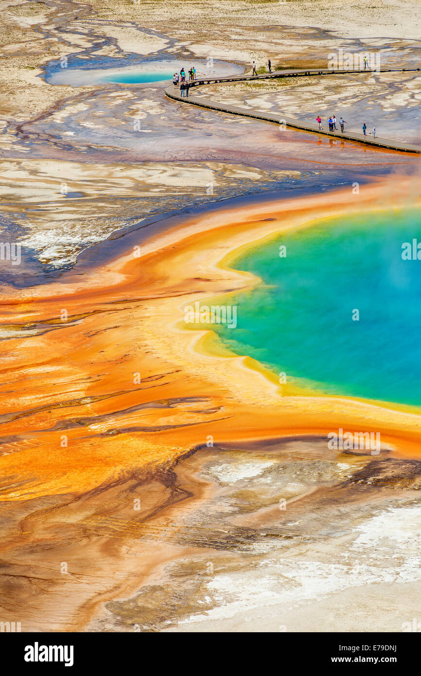 Grand Prismatic pool in Yellowstone National Park with tourists walking on the wooden boardwalk Stock Photo