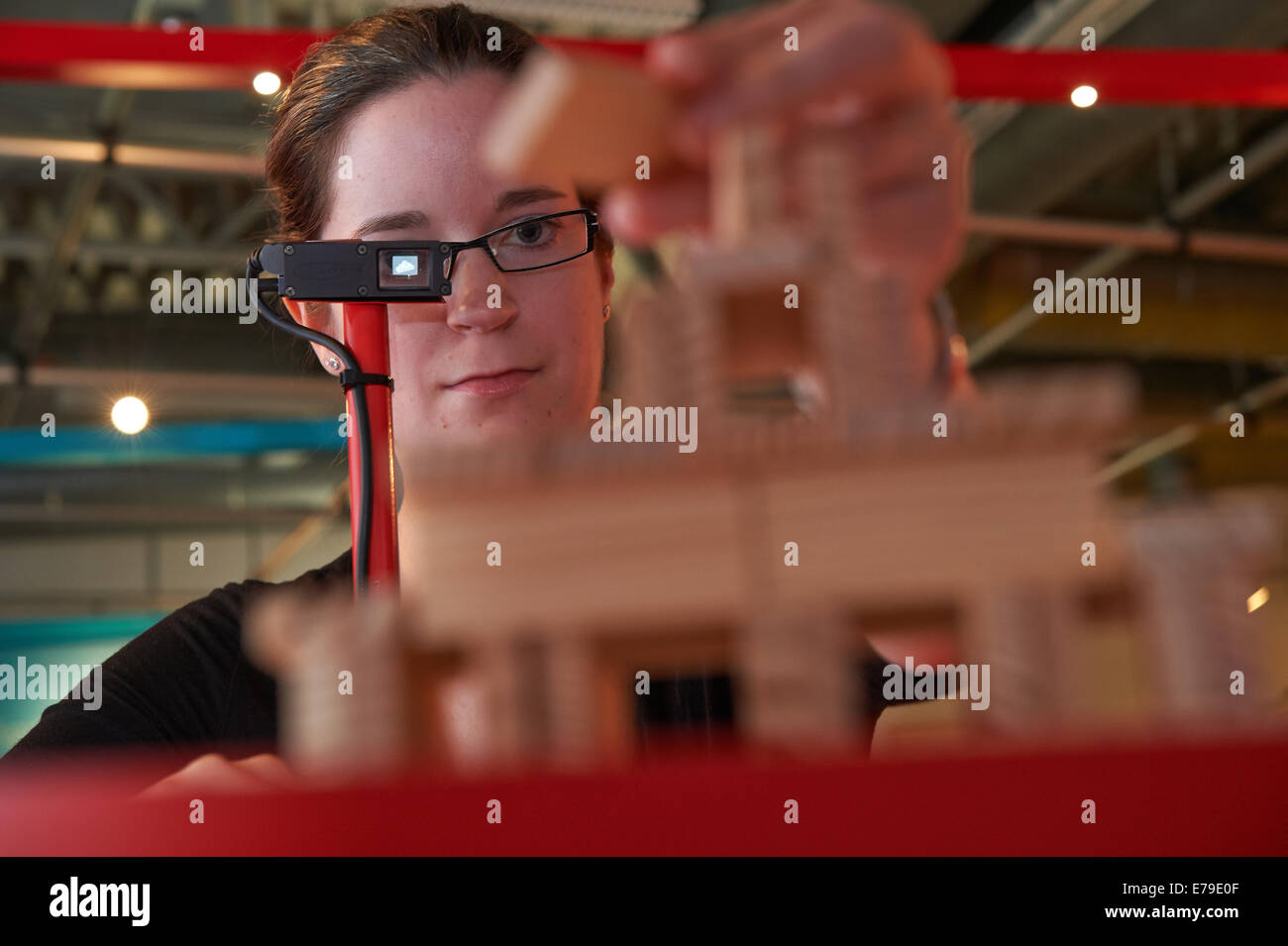 Dortmund, Germany. 10th Sep, 2014. DASA employee Jana Rech looks through data glasses showing a construction plan for a tower made of building bricks which she follows while building the tower in the exhibition «Schoene schlaue Arbeitswelt» (lit: Beautiful intelligent working world) at DASA Working World Exhibition in Dortmund, Germany, 10 September 2014. The exhibition explores technical possibilities in workspaces and runs from 11 September to 23 November 2014. Photo: Bernd Thissen/dpa/Alamy Live News Stock Photo