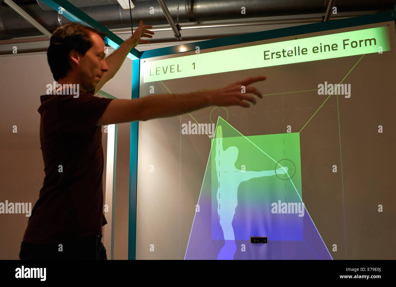 Dortmund, Germany. 10th Sep, 2014. DASA employee Daniel Nolle demonstrates the functioning of the 'Digital Ergonomy' translating human measures and movements into a digital world in the exhibition «Schoene schlaue Arbeitswelt» (lit: Beautiful intelligent working world) at DASA Working World Exhibition in Dortmund, Germany, 10 September 2014. The exhibition explores technical possibilities in workspaces and runs from 11 September to 23 November 2014. Photo: Bernd Thissen/dpa/Alamy Live News Stock Photo