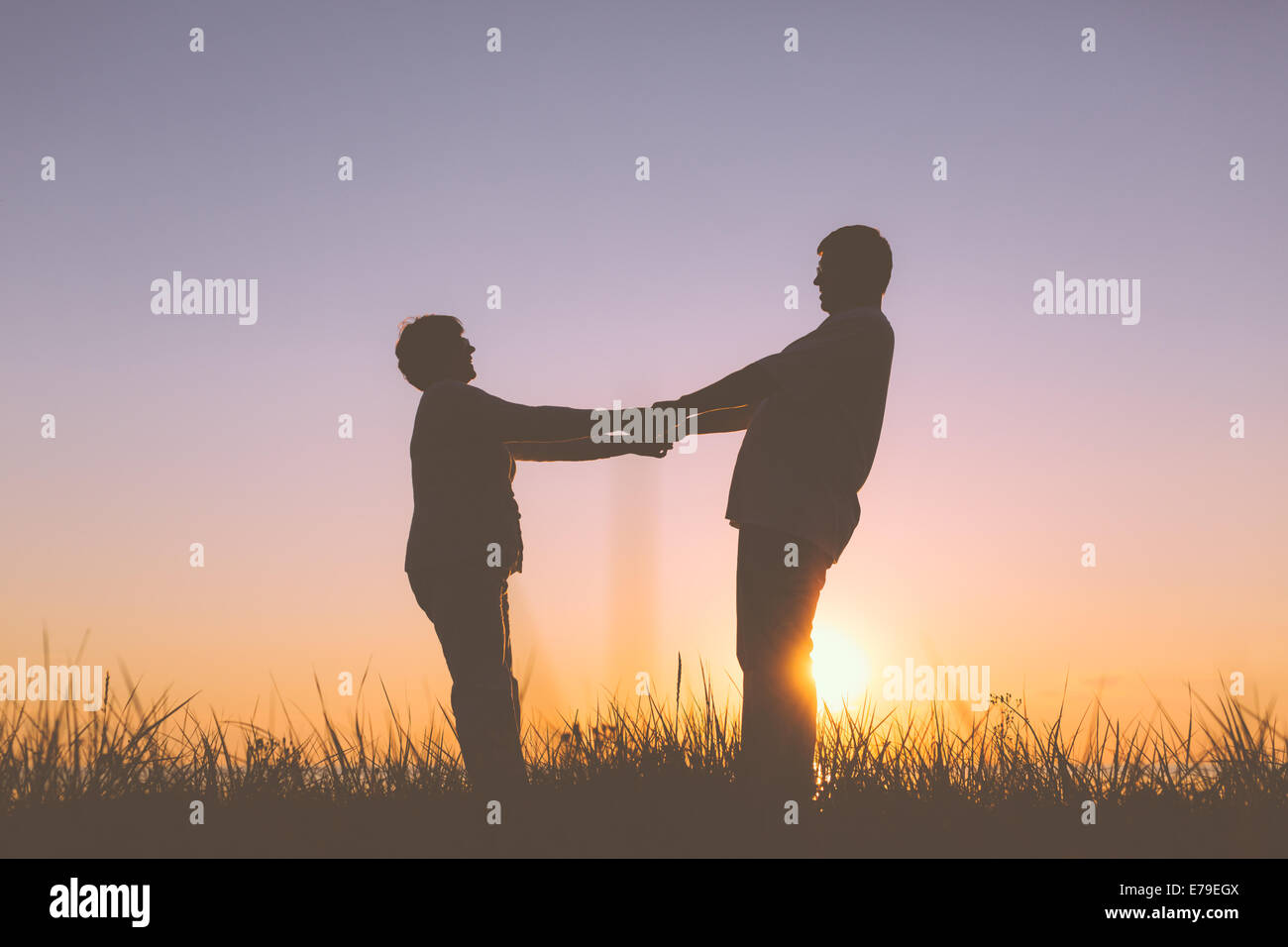 Senior couple holding hands silhouettes Stock Photo