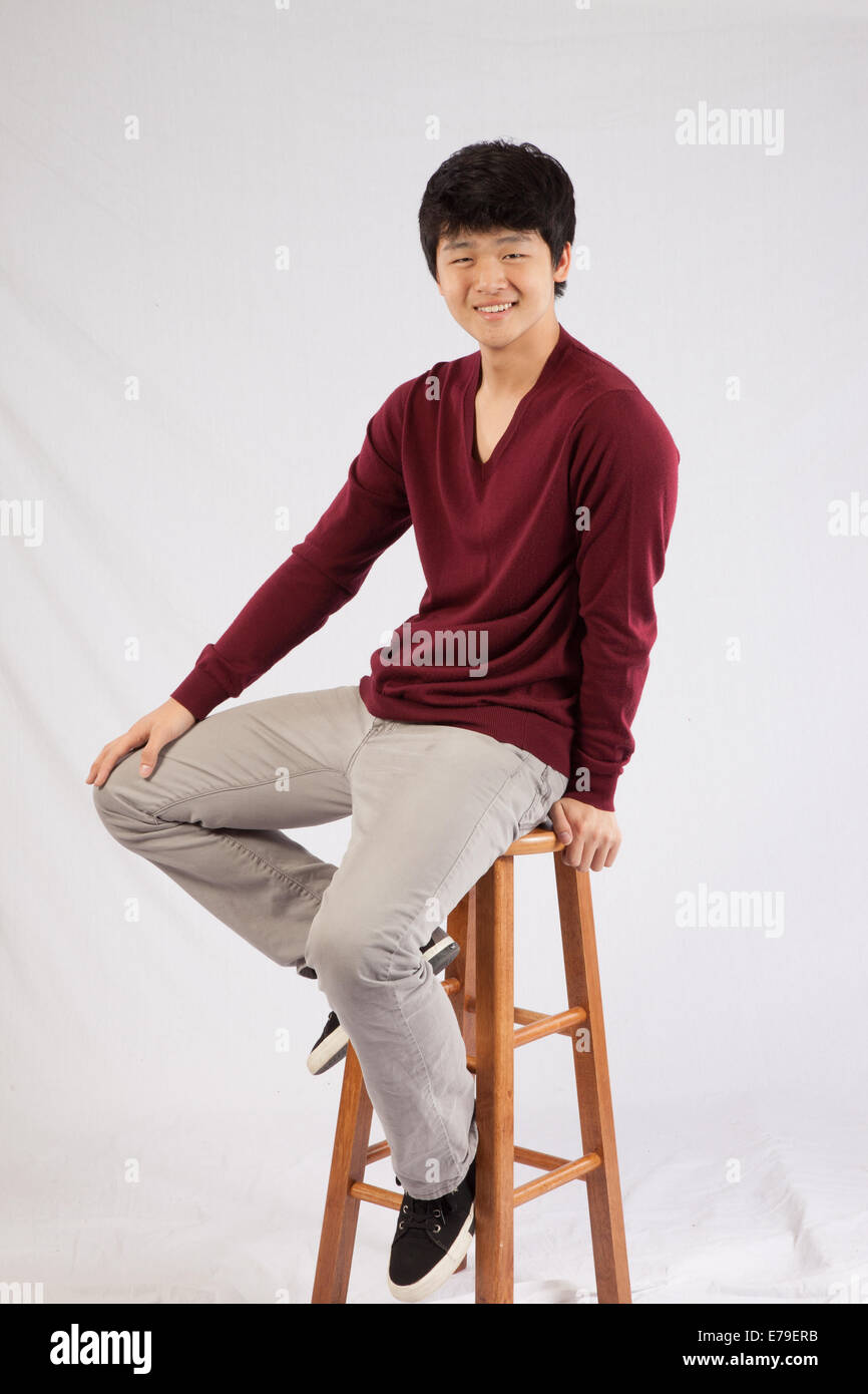 Asian man sitting and smiling at the camera Stock Photo