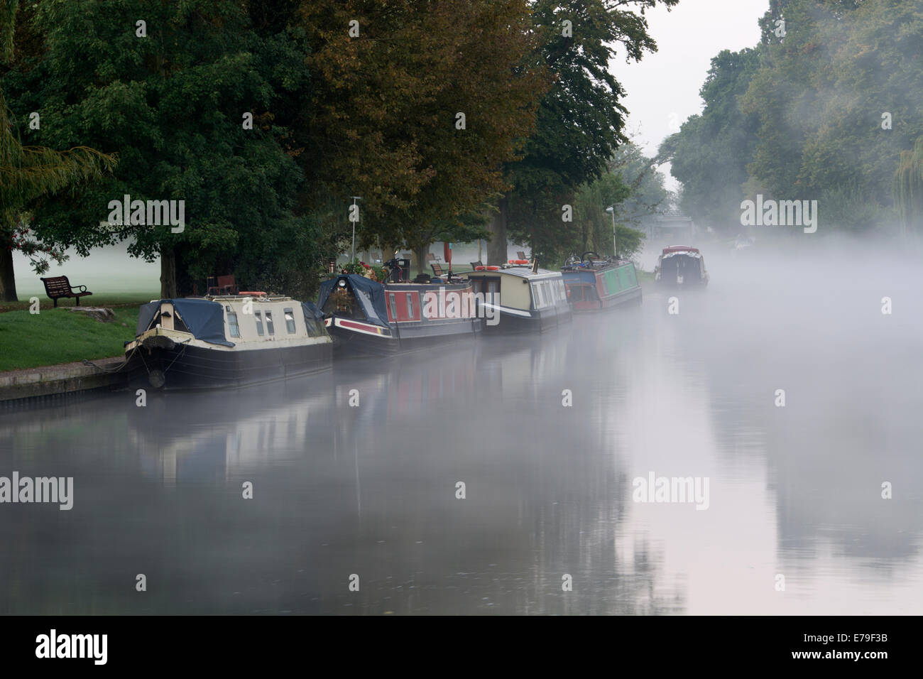 Narrowboats moored on River Avon, misty at dawn, Stratford-upon-Avon, UK Stock Photo