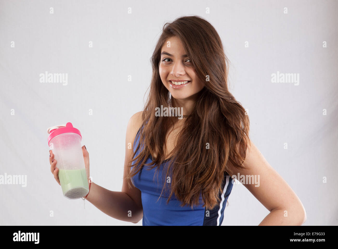 Pretty Caucasian woman with a shake bottle, smiling at the camera Stock Photo