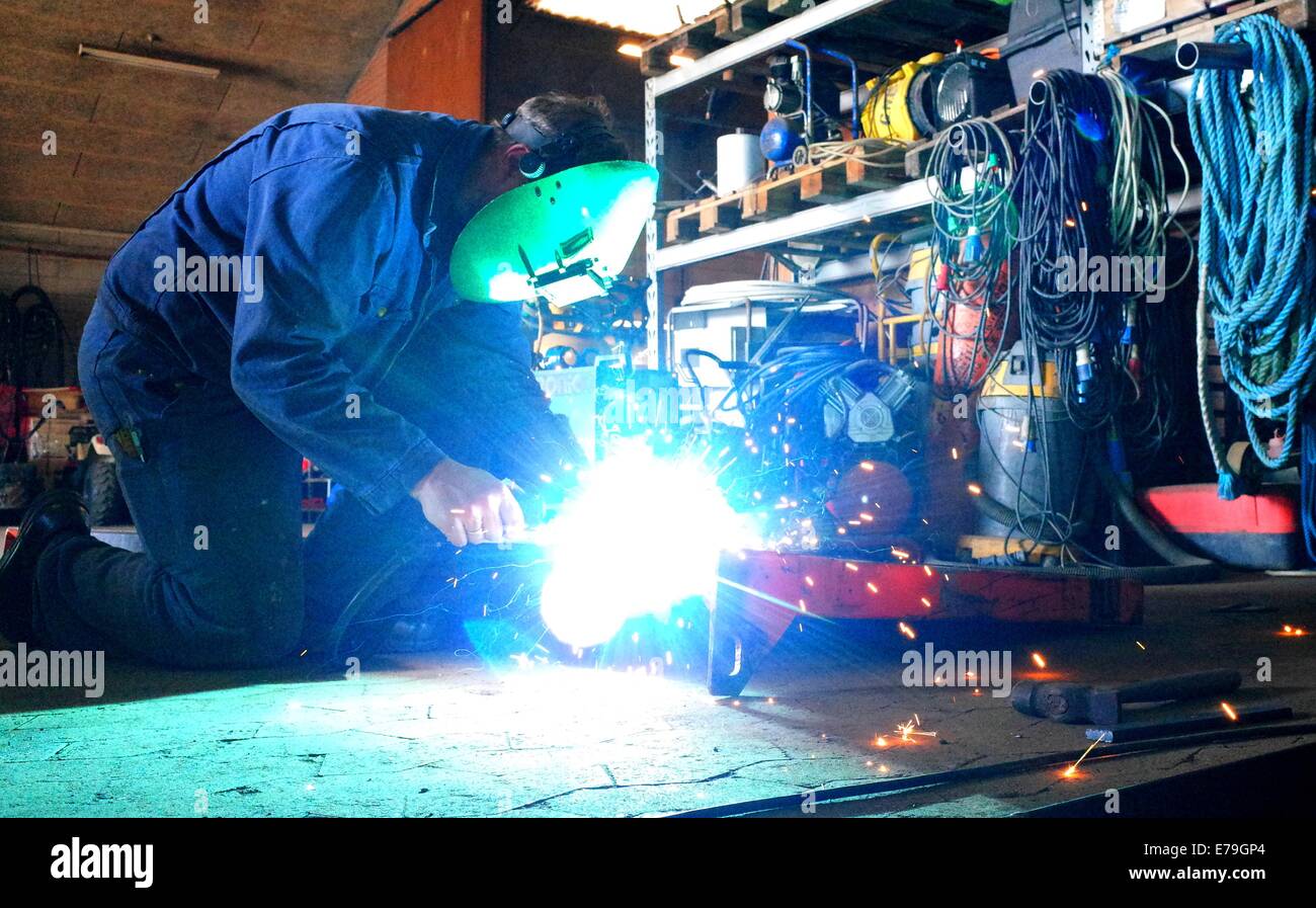 Welder in work with welding in the workshop Stock Photo