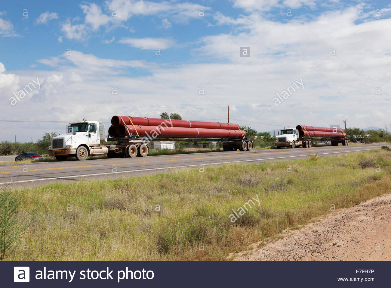 Two Trucks hauling steel pipe for natural gas pipeline Arizona 3 foot