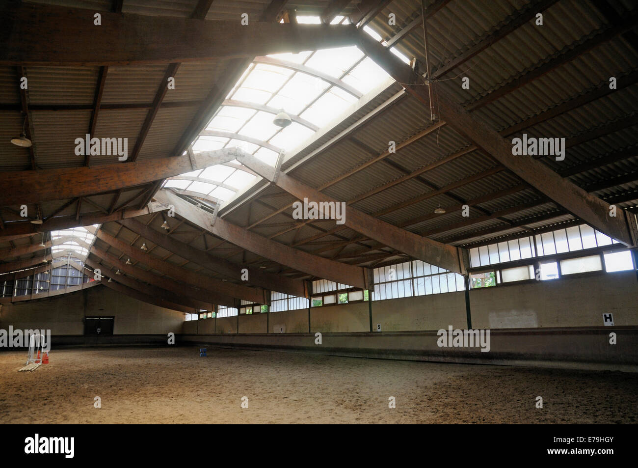 Empty indoor horse riding area at a riding school Stock Photo