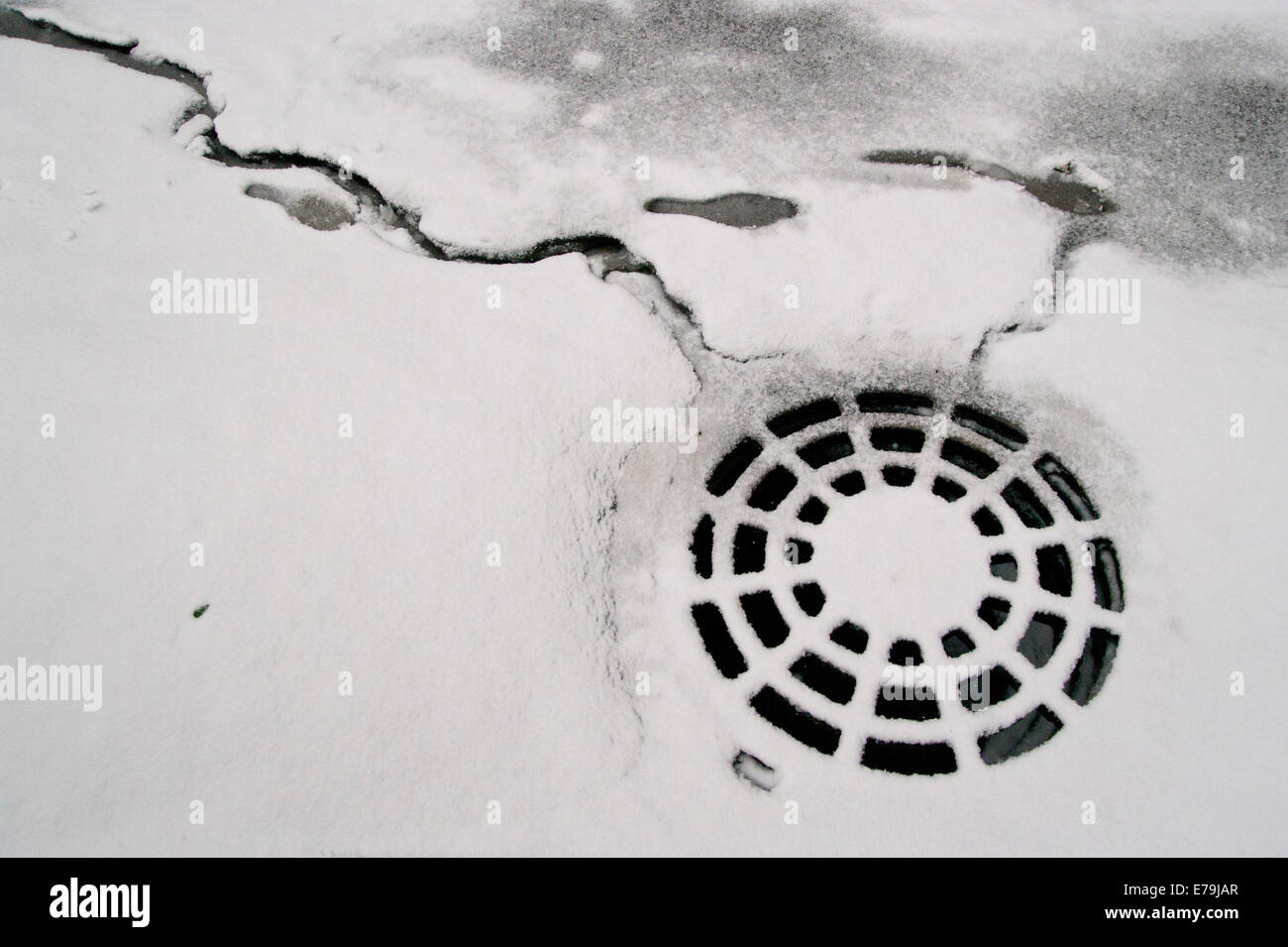 Footsteps on snow near sanitation hatchway Stock Photo
