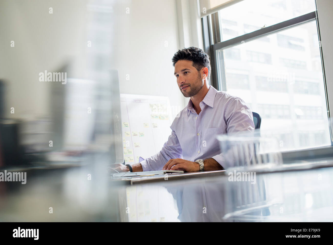 Office life. A man working alone in an office. Stock Photo