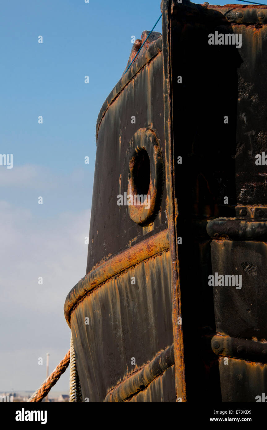 The bow of a black ship with a lot of rust Stock Photo