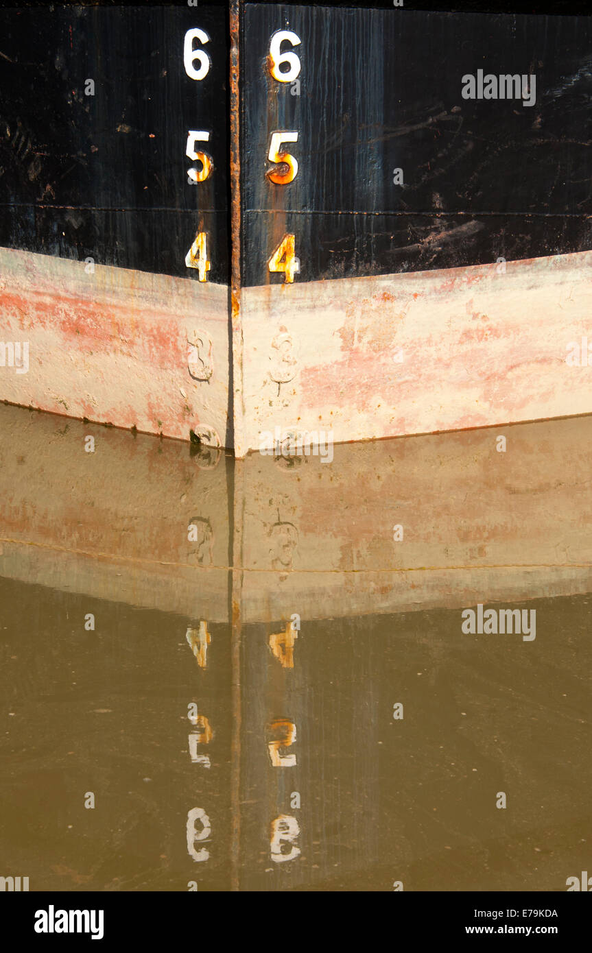 Reflection of ship bow markings in brown water Stock Photo