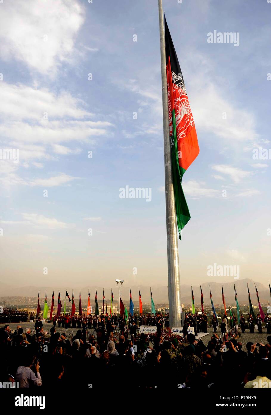 Kabul, Afghanistan. 10th Sep, 2014. People attend a flag raising ceremony in Kabul, Afghanistan on Sept. 10, 2014. Afghan President Hamid Karzai and Indian External Affairs Minister Sushma Swaraj on Wednesday hoisted an India-made Afghanistan national flag with 87 meter length and 30 meters width during the ceremony. Credit:  Ahmad Massoud/Xinhua/Alamy Live News Stock Photo