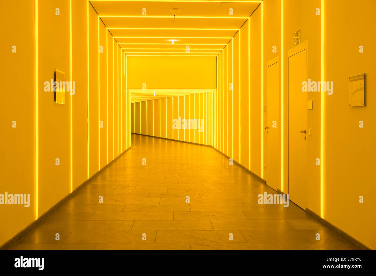 Interior of passageway lit by yellow strip lights under government buildings in Berlin Germany Stock Photo