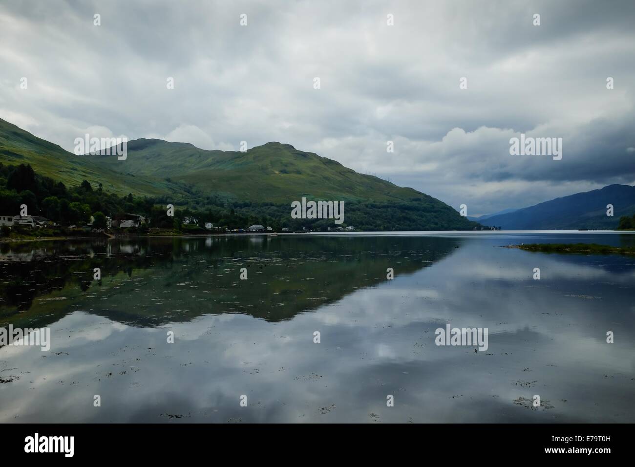 Loch reflection - Hills and clouds reflected in a Scottish loch Stock Photo